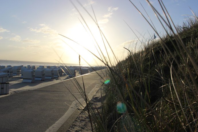 Blick auf den Strand mit Strandkörben im Sonnenaufgang, © Kurverwaltung Wangerooge